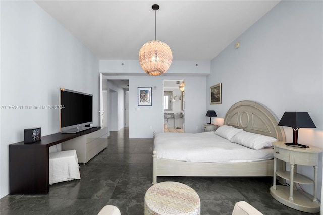 bedroom featuring an inviting chandelier and ensuite bathroom