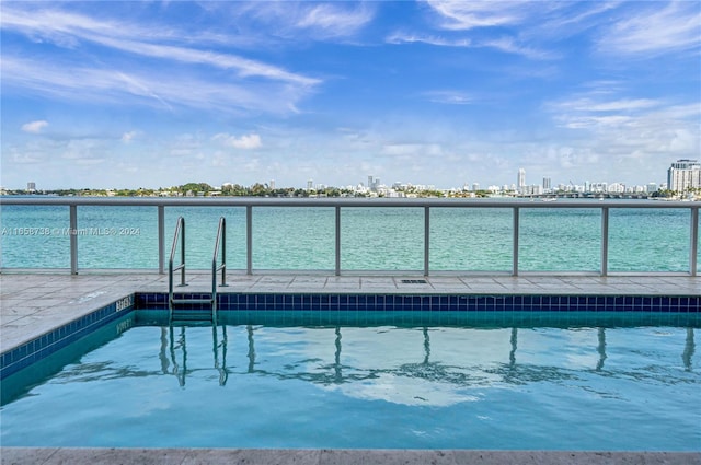 view of pool featuring a water view