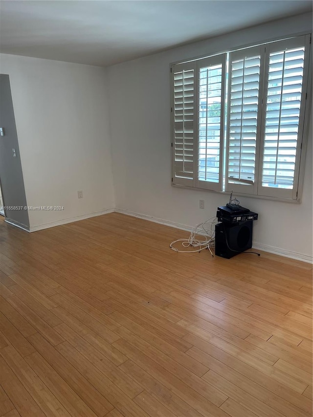 unfurnished room with plenty of natural light and light hardwood / wood-style flooring