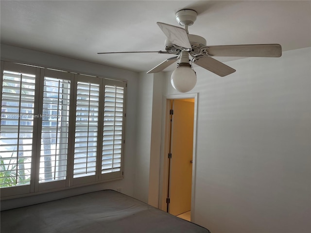 unfurnished bedroom featuring ceiling fan