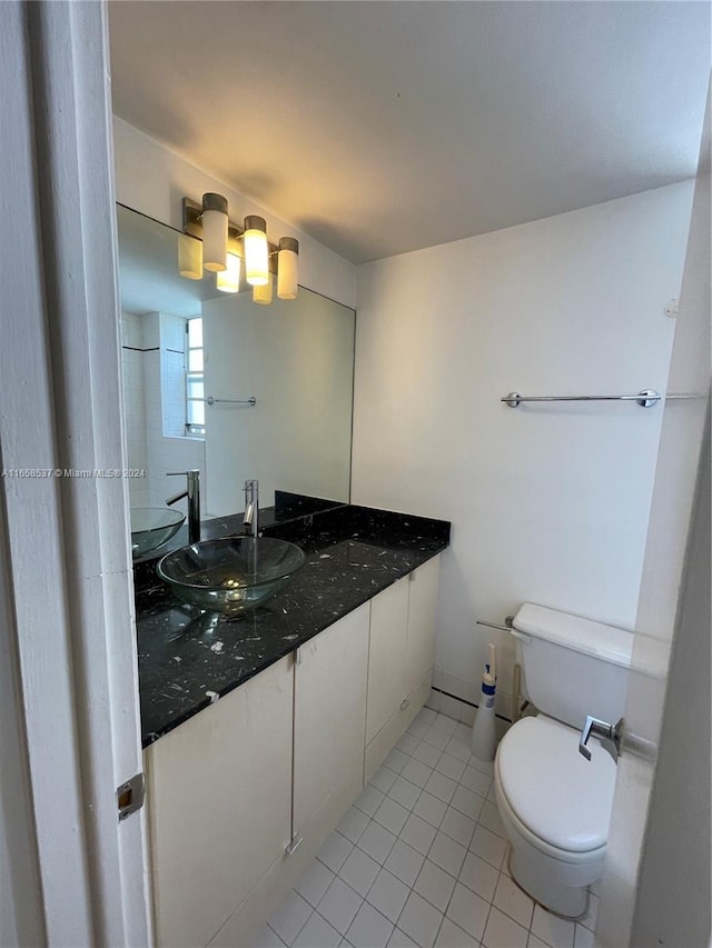 bathroom featuring vanity, toilet, and tile patterned flooring