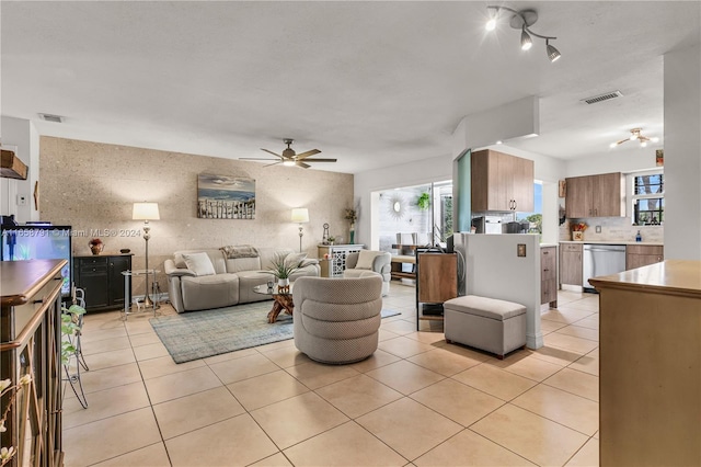 living room with ceiling fan and light tile patterned floors