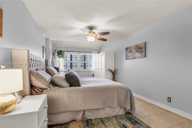 tiled bedroom featuring ceiling fan