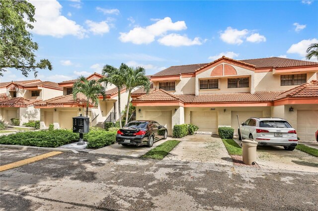 3507 Emerald Oaks Dr Unit 1804, Hollywood, FL 33021 - view of front of property featuring a tiled roof, driveway, stucco siding, and a residential view