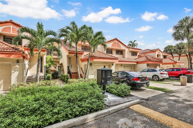 3507 Emerald Oaks Dr Unit 1804, Hollywood, FL 33021 - view of property with a tile roof, a garage, driveway, and stucco siding