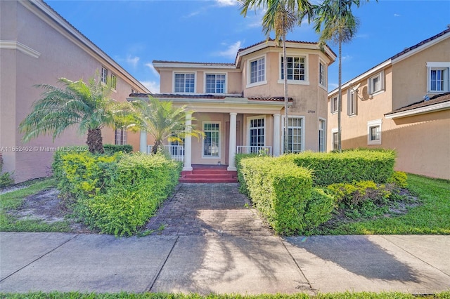 mediterranean / spanish-style home with covered porch