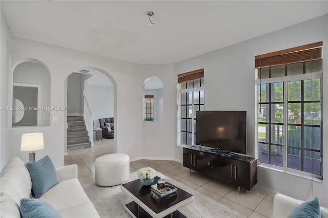 living room with a wealth of natural light and light tile patterned floors