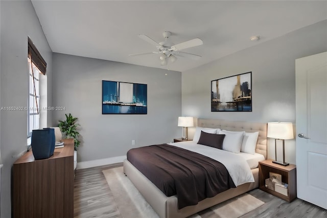 bedroom with light hardwood / wood-style flooring and ceiling fan