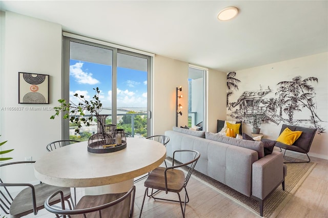 dining area featuring light hardwood / wood-style floors and expansive windows