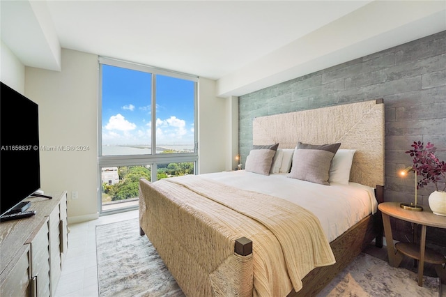 tiled bedroom featuring floor to ceiling windows