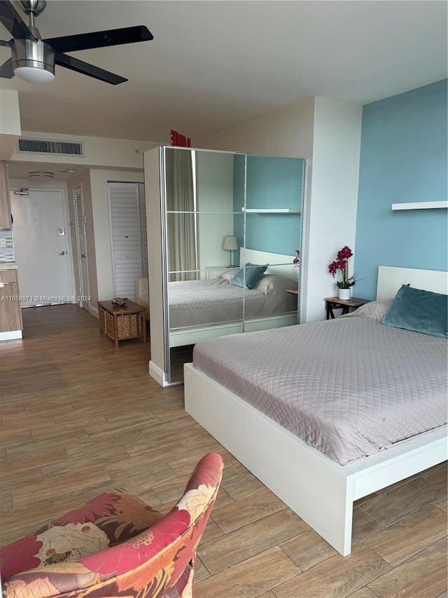 bedroom featuring hardwood / wood-style floors and ceiling fan