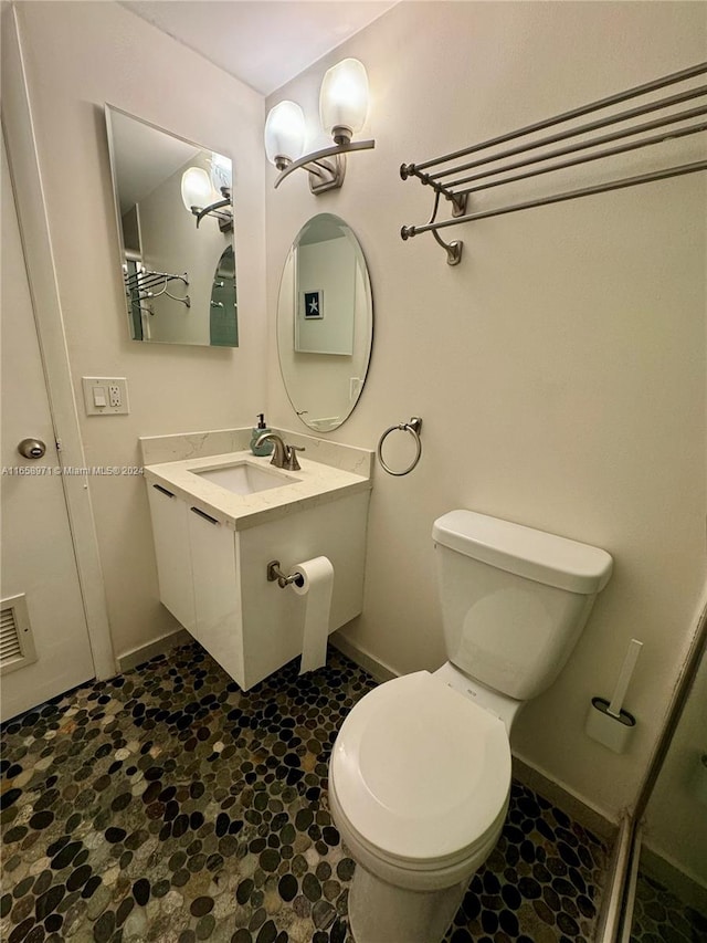 bathroom with toilet and vanity