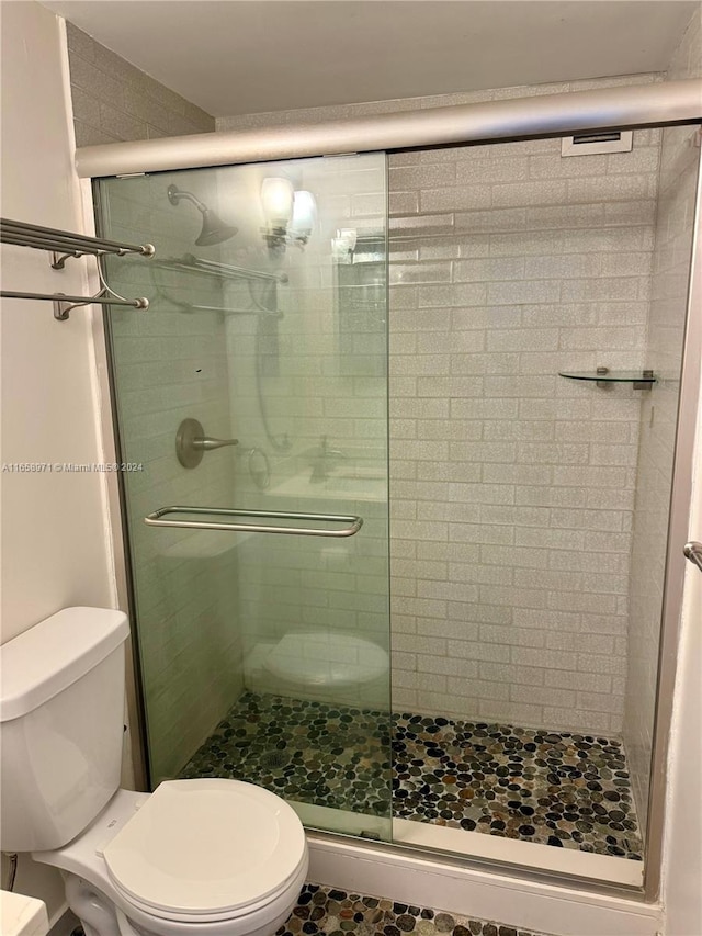 bathroom with walk in shower and toilet