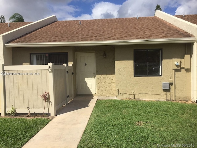 property entrance with a yard