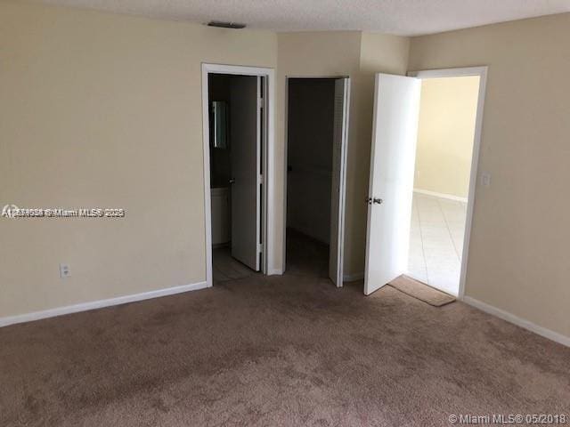 unfurnished bedroom featuring carpet