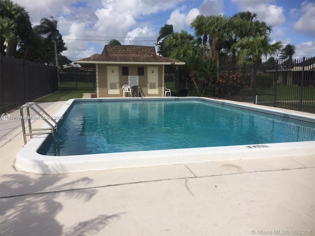 view of pool featuring an outbuilding and a patio area