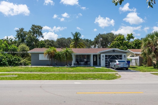 ranch-style home with a front yard and a garage