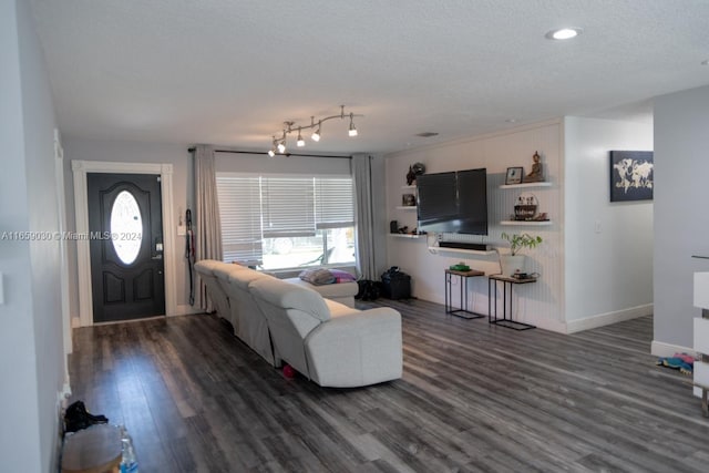 living room with dark hardwood / wood-style floors and a textured ceiling