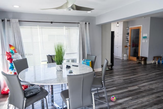 dining space featuring dark wood-type flooring and ceiling fan