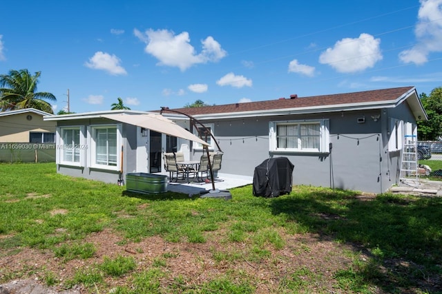 rear view of house with a patio area and a yard