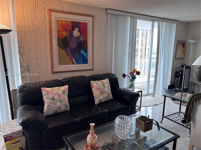 living room with light tile patterned floors and a textured ceiling