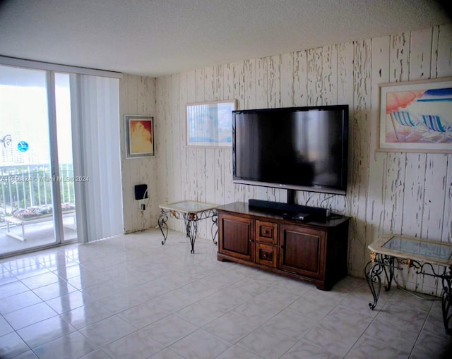 tiled living room featuring a textured ceiling