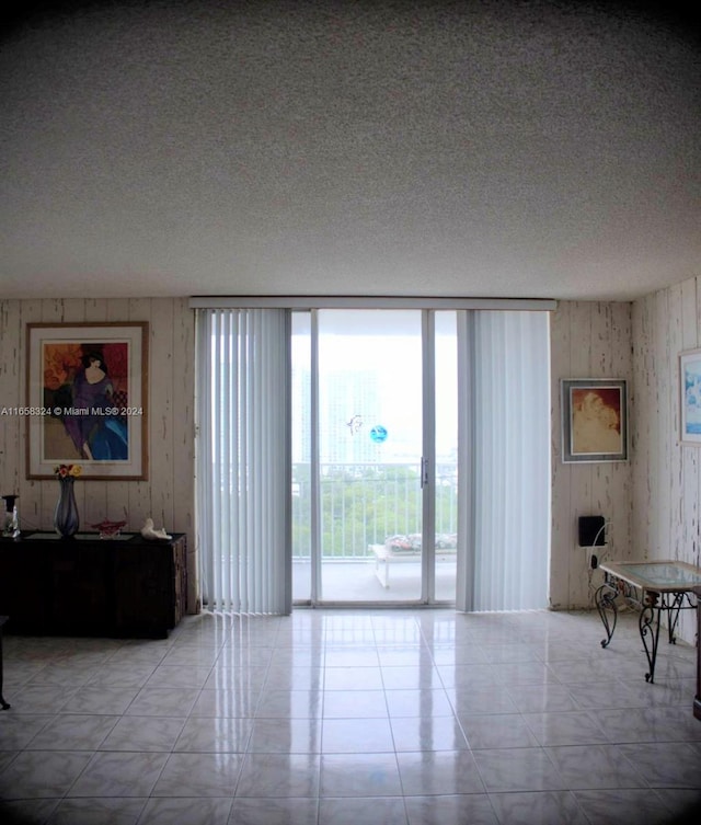 living room with light tile patterned flooring and a textured ceiling