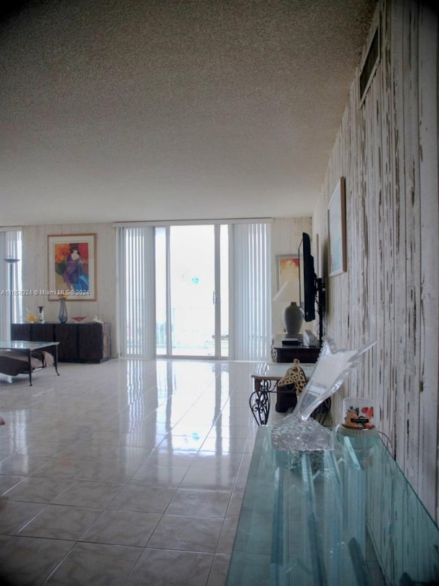 unfurnished living room with a textured ceiling and tile patterned floors