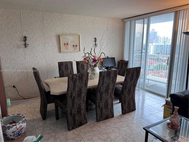 dining area featuring light tile patterned flooring and a textured ceiling