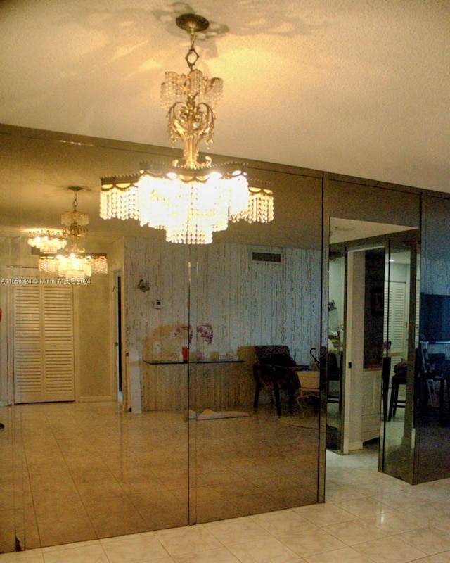 dining room featuring tile patterned floors and a chandelier