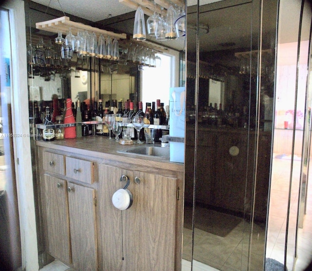 bar with light brown cabinetry