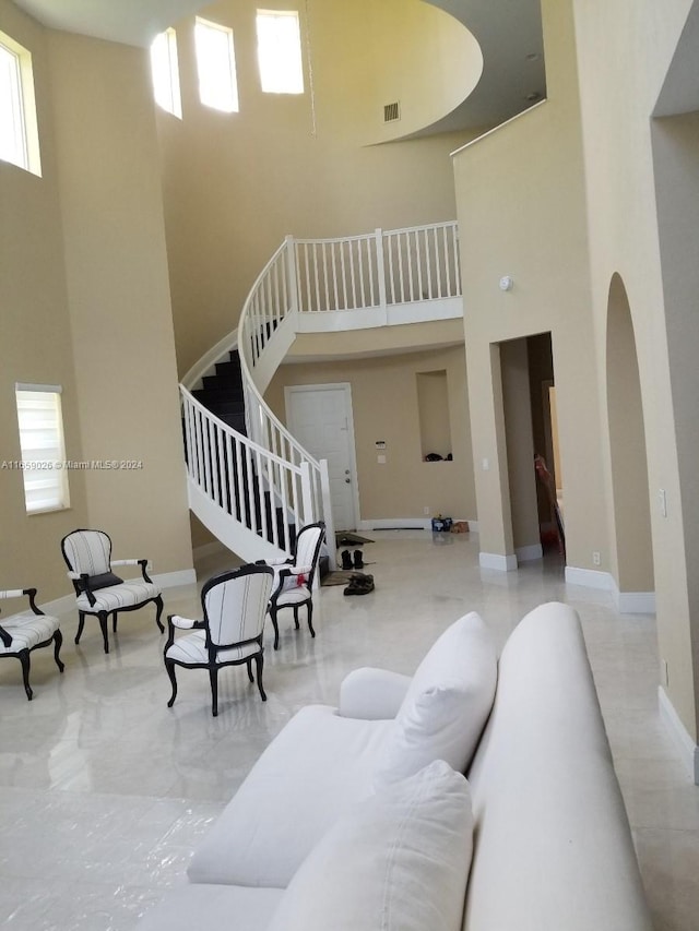 living room featuring a towering ceiling