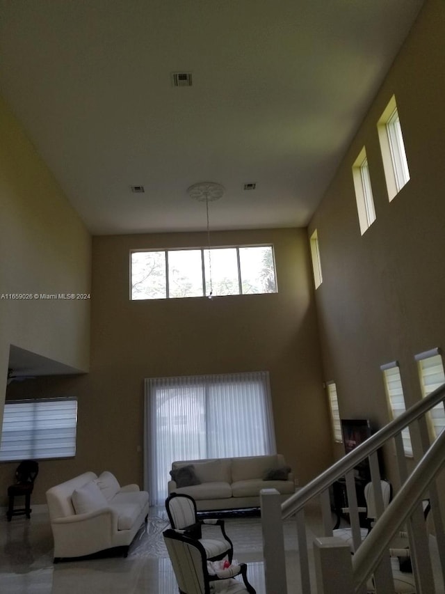 living room featuring a high ceiling