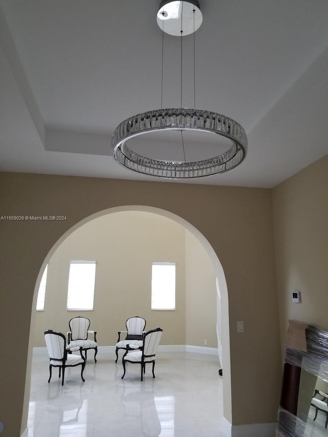 sitting room with a raised ceiling