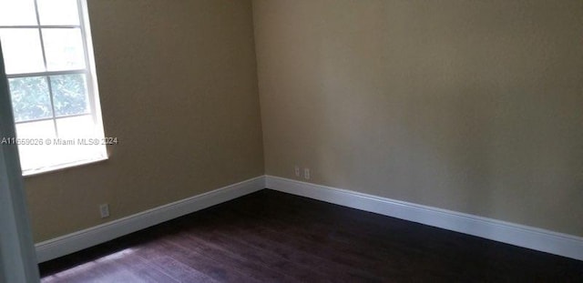 spare room featuring dark hardwood / wood-style flooring