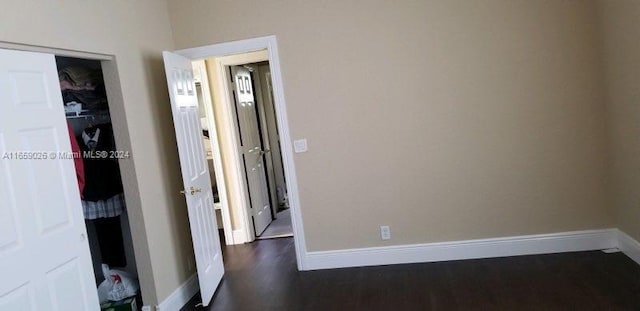 corridor featuring dark hardwood / wood-style flooring