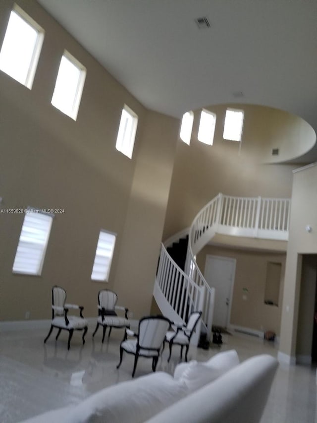 staircase with carpet and a high ceiling