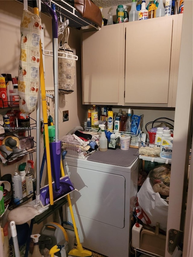 laundry area with gas water heater, cabinets, and washer / clothes dryer