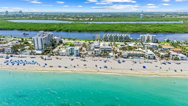 birds eye view of property featuring a water view and a beach view