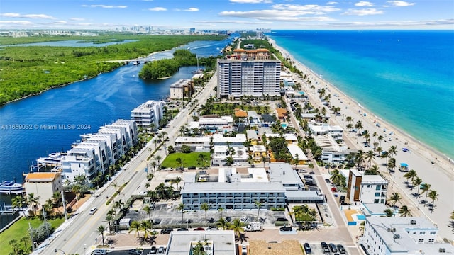 birds eye view of property with a water view and a view of the beach