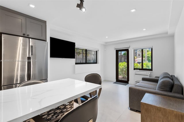 kitchen featuring stainless steel fridge and light stone countertops