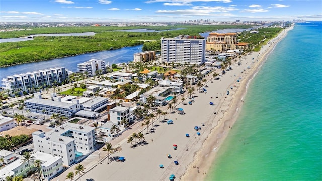 birds eye view of property featuring a beach view and a water view