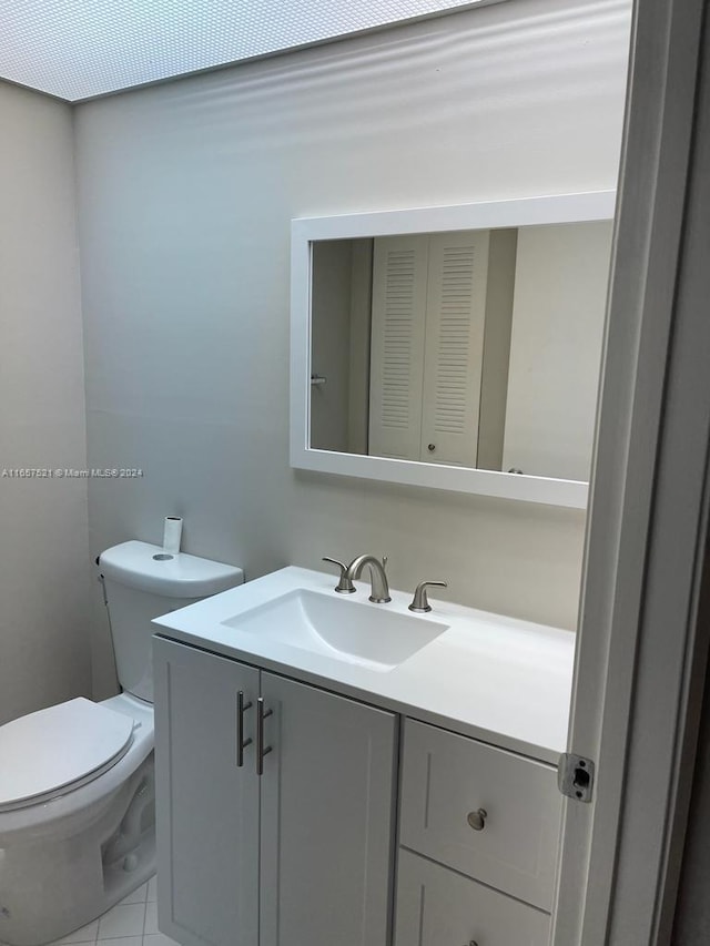 bathroom featuring vanity, toilet, and tile patterned floors