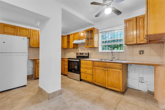 kitchen featuring tasteful backsplash, sink, ceiling fan, white refrigerator, and stainless steel range with electric cooktop