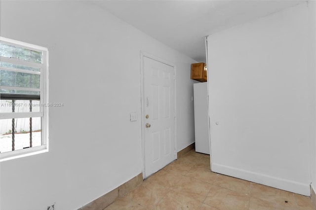 unfurnished room featuring plenty of natural light