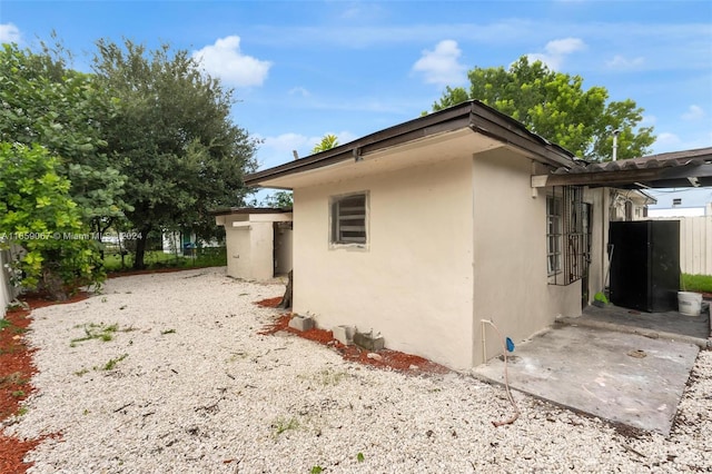 view of side of property featuring a patio