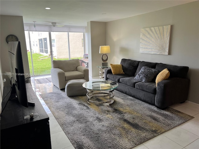 tiled living room featuring floor to ceiling windows and ceiling fan