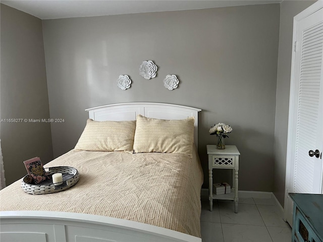 bedroom featuring light tile patterned flooring