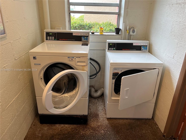 clothes washing area with washer and clothes dryer