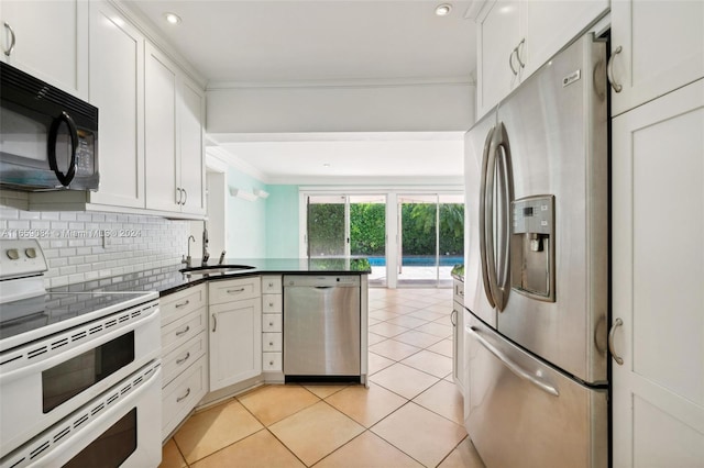 791 Allendale Rd, Key Biscayne, FL 33149 - kitchen featuring stainless steel appliances, a sink, crown molding, a peninsula, and tasteful backsplash
